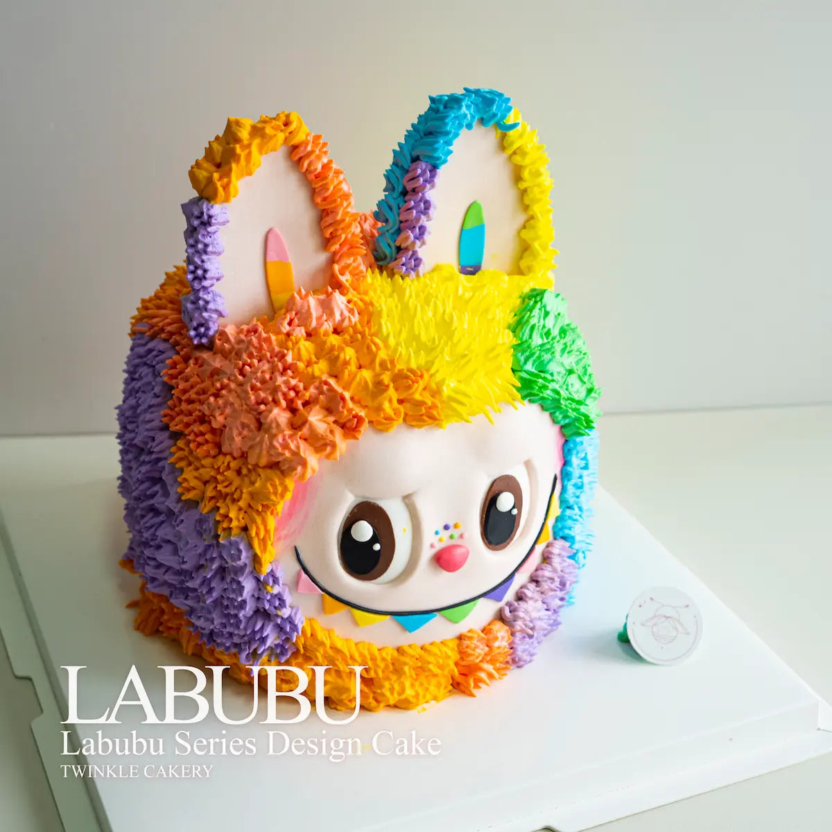 Colorful cake designed like a character with rainbow fur, featuring the brand 'LABUBU'. Delivery across Kuala Lumpur