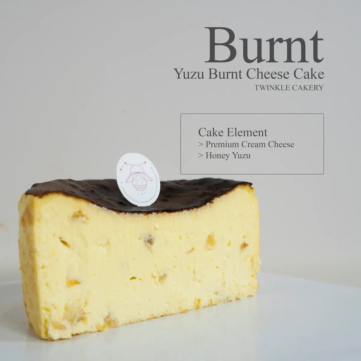 Cross section slice showing the creamy citrus cream cheese interior of a yuzu burnt cheesecake.