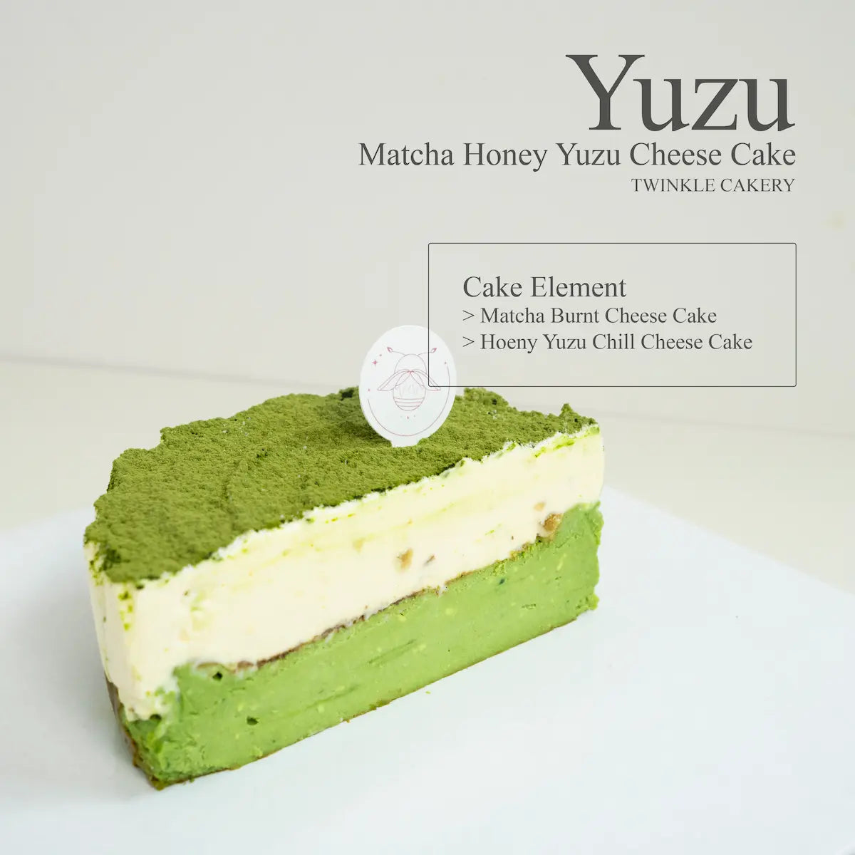 Cross section slice displaying a baked green tea cheesecake base below a light yellow honey yuzu mousse layer.