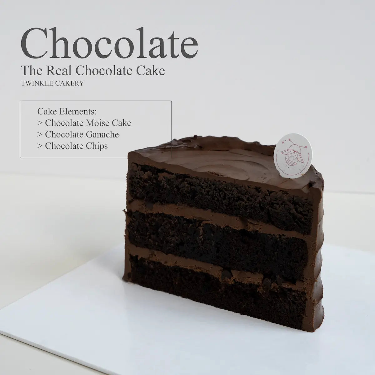 Cross section slice showing moist chocolate cake layered with rich 58 percent dark chocolate ganache.