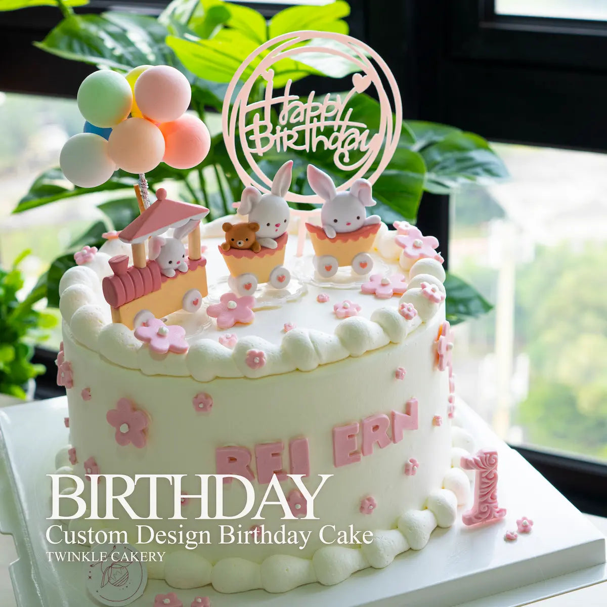 Pink balloon, train, and flower decorations on kids birthday cake - delivery across selangor