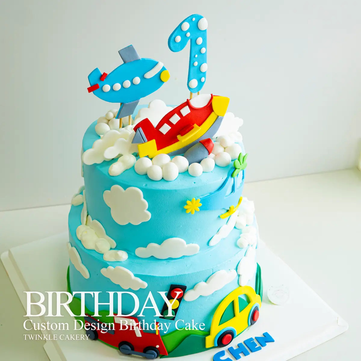 Two-tier transportation cake design showing different vehicle levels - Kuala Lumpur