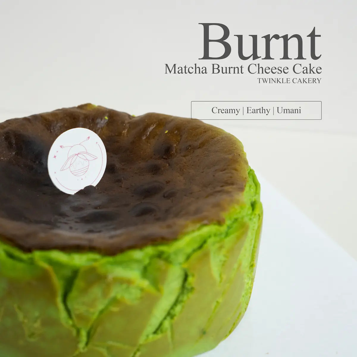 Detailed close up view of the rustic caramelized top on a fondant free matcha burnt cheesecake.