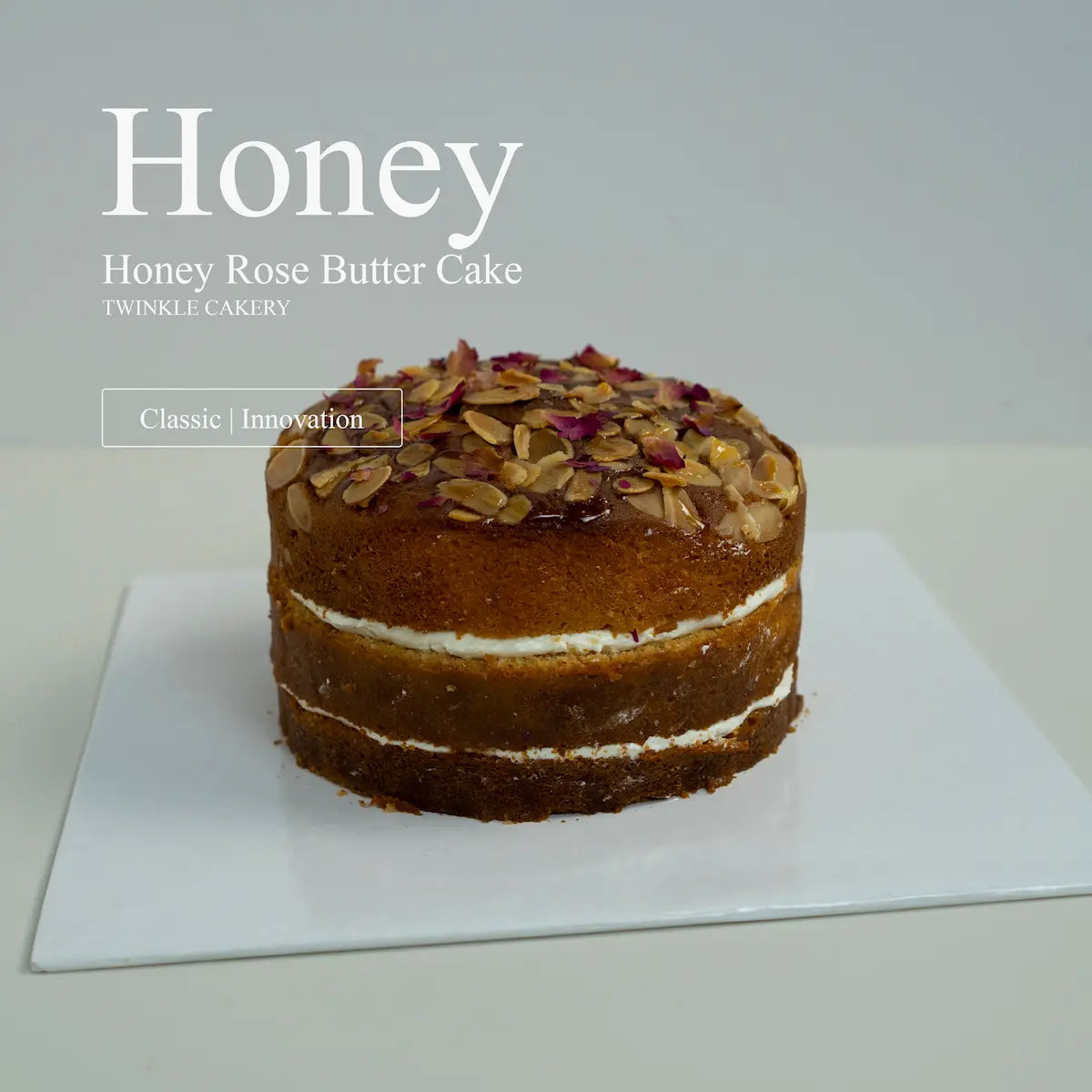 An artisan honey rose butter cake receiving final delicate design touches inside the Twinkle Cakery studio.