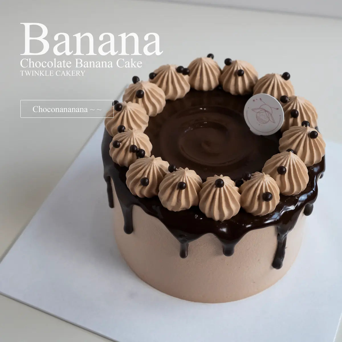 Detailed close up view of a glossy dark chocolate ganache drip design cascading down a fresh cream cake.