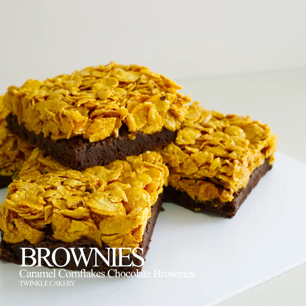Macro detail of classic rich butter caramel coated crisp cornflakes on a dark chocolate brownie base.