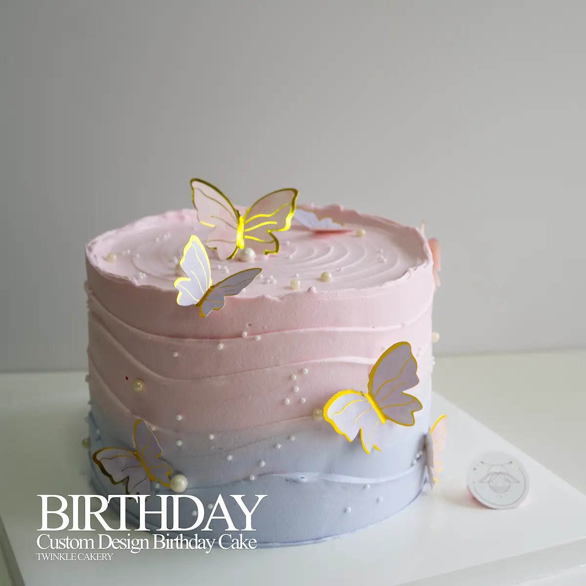 Close-up of shiny metallic butterflies arranged in flying formation around minimalist birthday cake. Delivery across Selangor and Kuala Lumpur