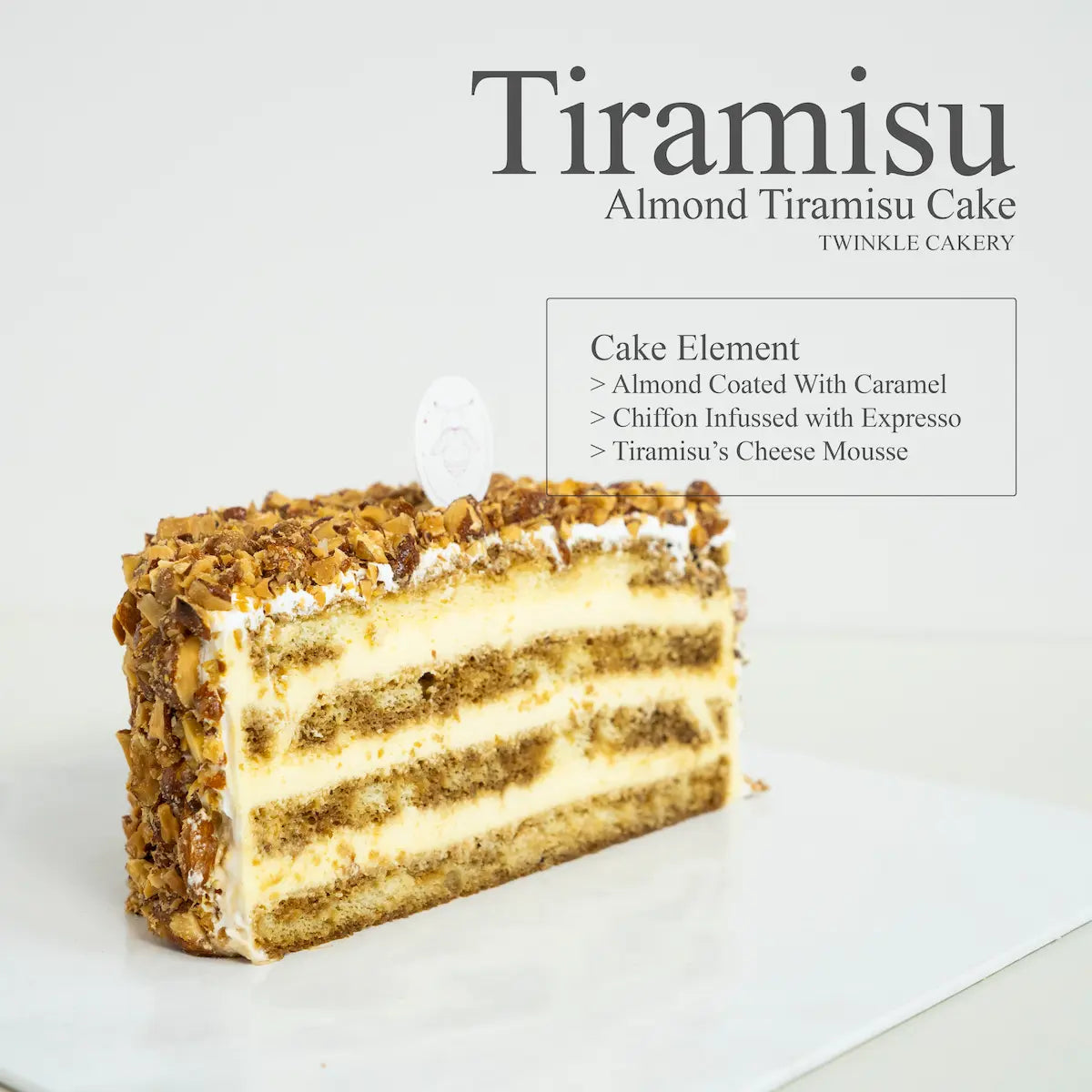 Cross section slice of almond tiramisu cake showing espresso soaked sponge and rich cream cheese layers.