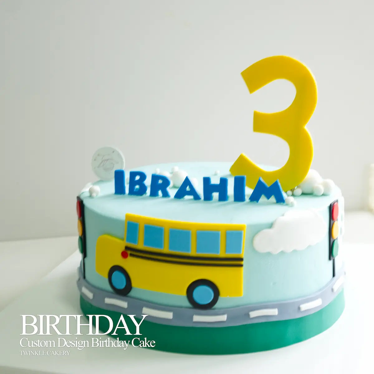 Fondant traffic lights and grey road scene detail on the Yellow Bus birthday cake