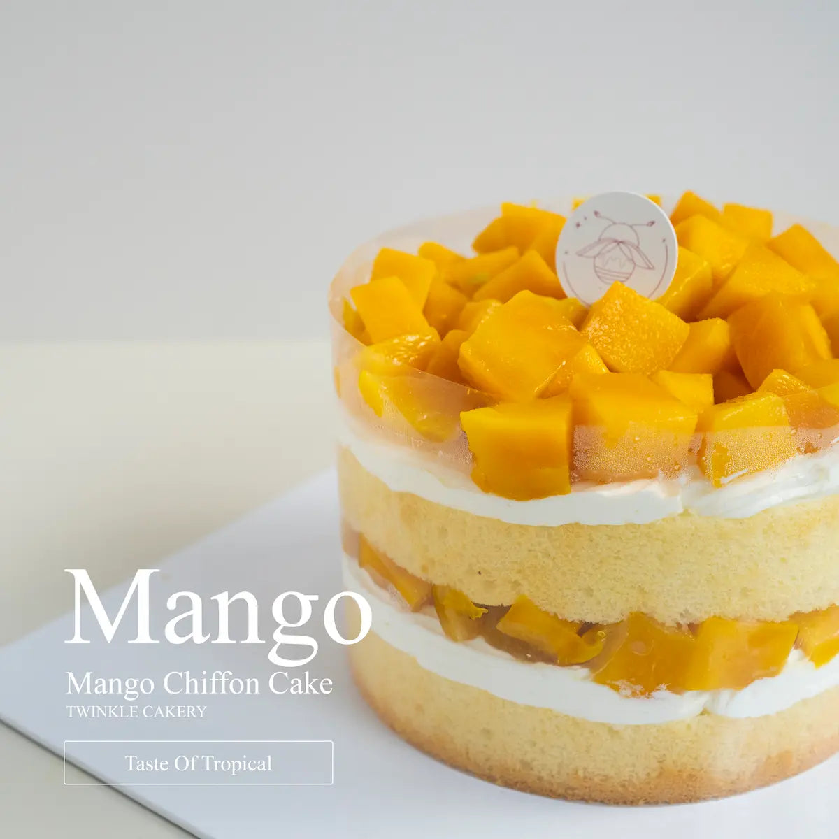 Top view of juicy fresh sweet mango cubes generously arranged on a naked chiffon birthday cake.