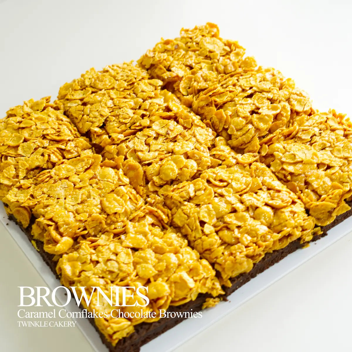 Cross-section showing dual layers: fudgy dark chocolate brownie base topped with butter caramel cornflakes.