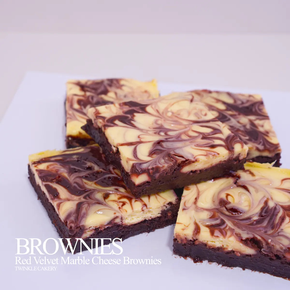 Cross-section showing dual layers: fudgy red velvet brownie base topped with baked marbled cream cheese.