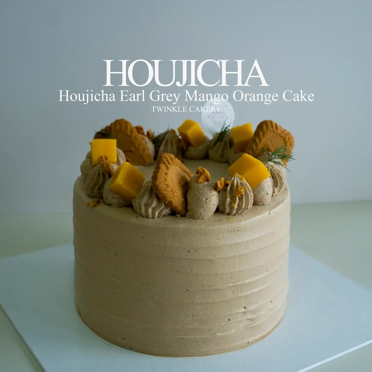 Houjicha Earl Grey mango orange cake frosted in houjicha fresh cream with fresh mango topping by Twinkle Cakery.
