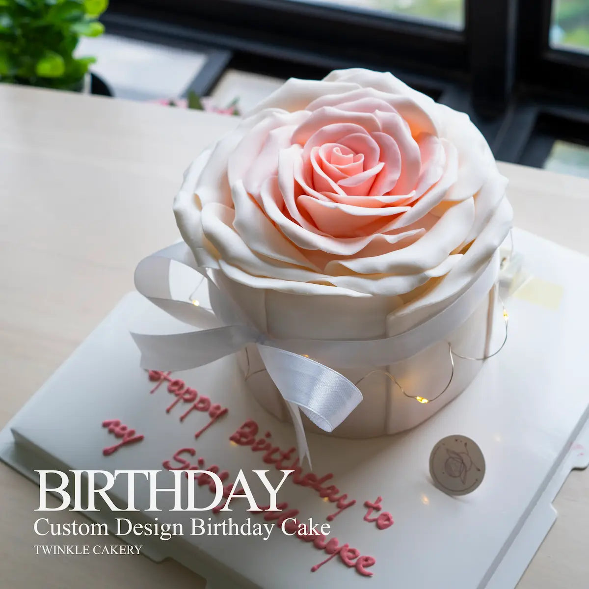 Custom design birthday cake shaped like a rose with a white ribbon on a table - delivery across kuala lumpur and selangor