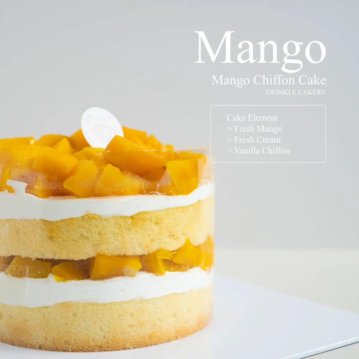 Slice of vanilla chiffon cake showing two inner layers of fresh mango cubes and light cream.