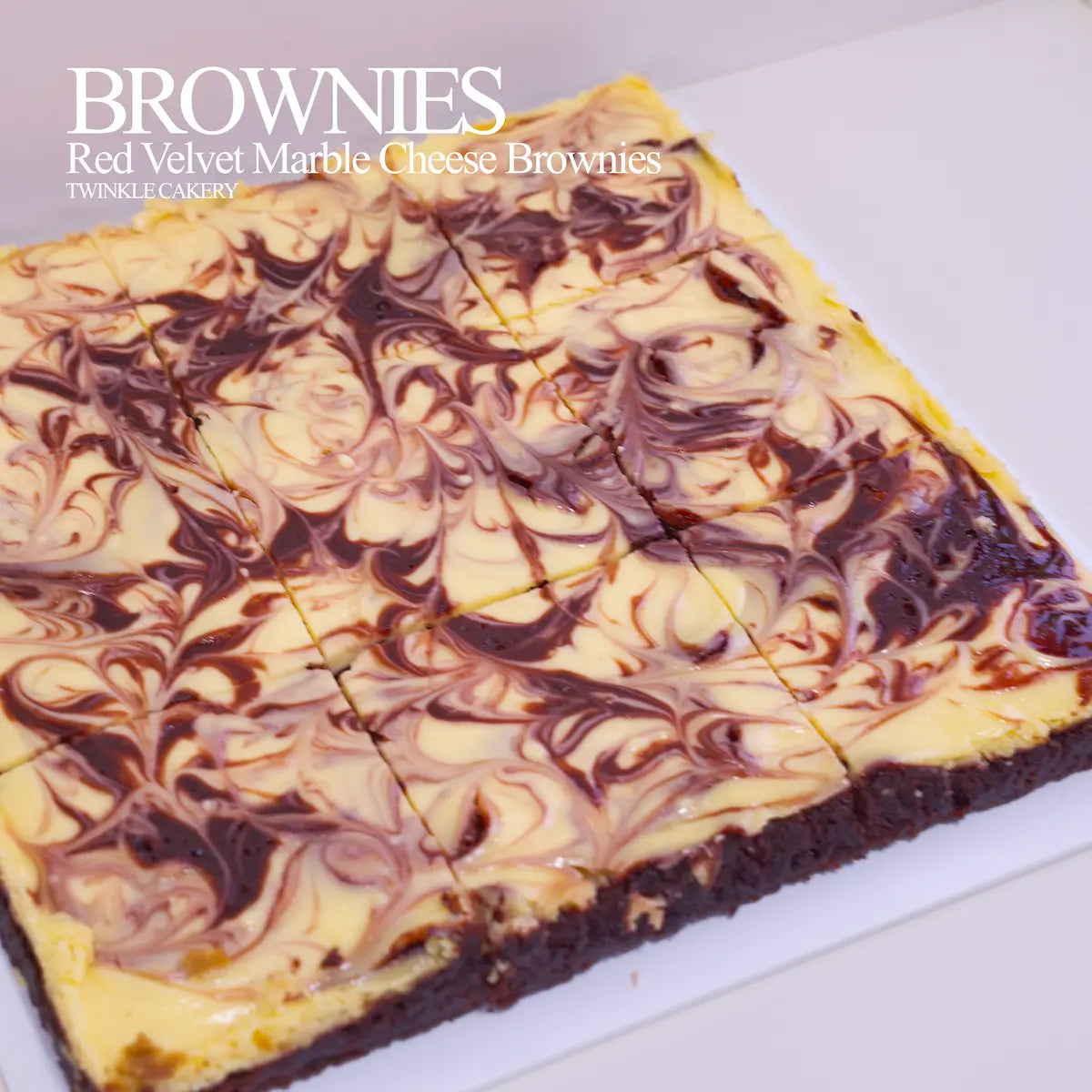 Macro detail of tangy marbled cream cheese swirled over rich red velvet cocoa brownie base.