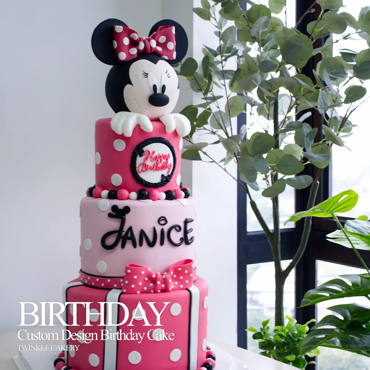 Minnie Mouse 3-layer cake in pink birthday party setting - Twinkle Cakery