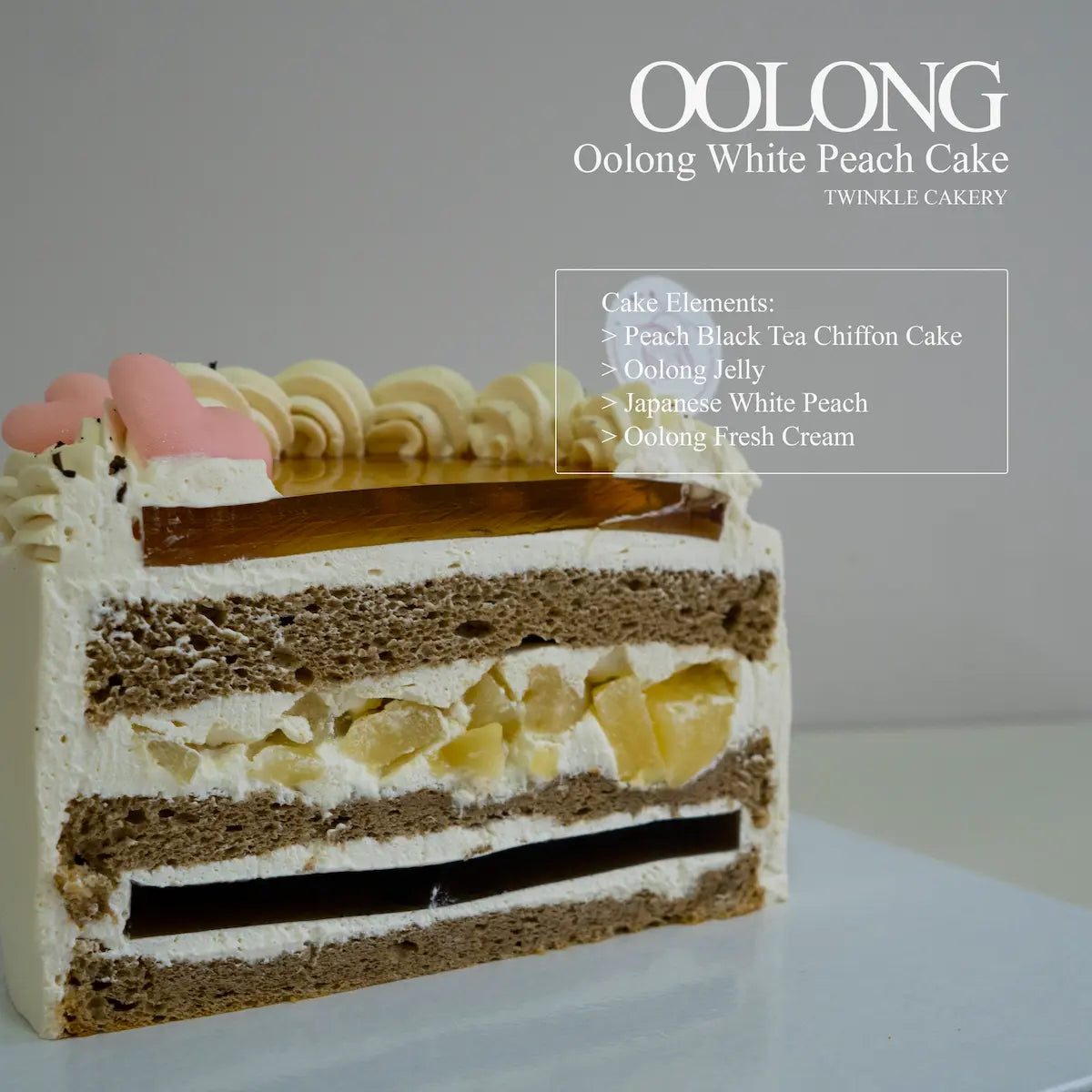 Cake slice showing oolong chiffon sponge, oolong tea jelly layer, and imported Japanese white peaches.