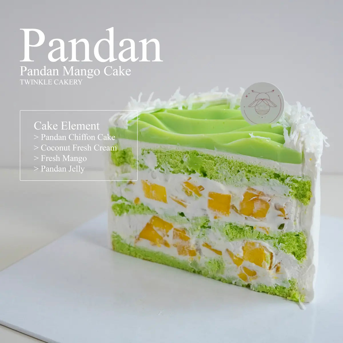 Slice of green pandan chiffon cake showing two inner layers of fresh sweet mango cubes.