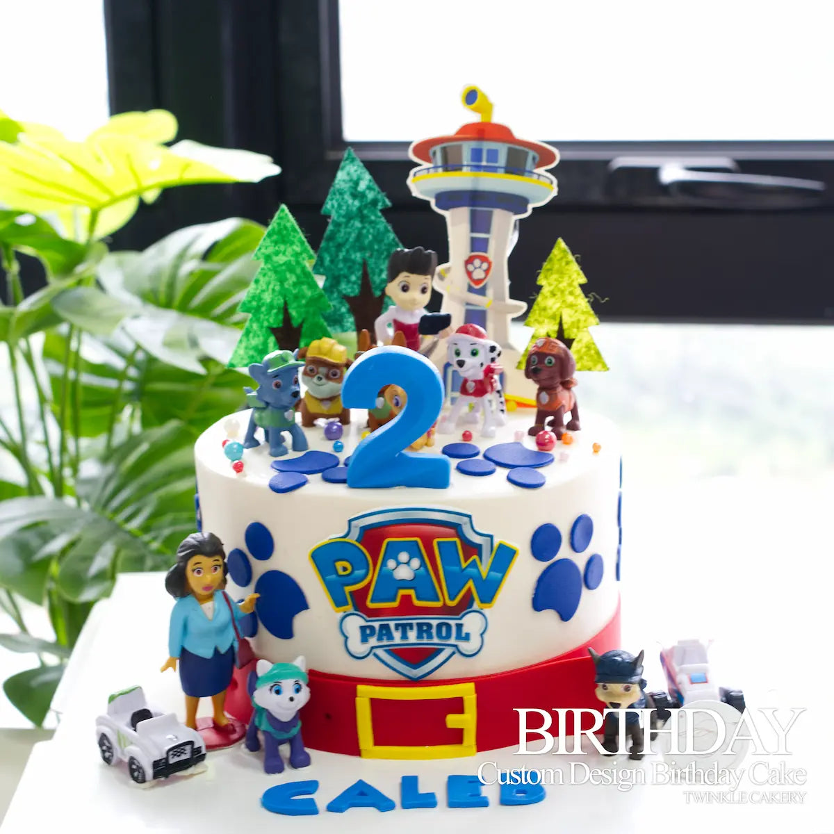 Paw Patrol birthday cake as centerpiece on a kids party table with balloons and decorations