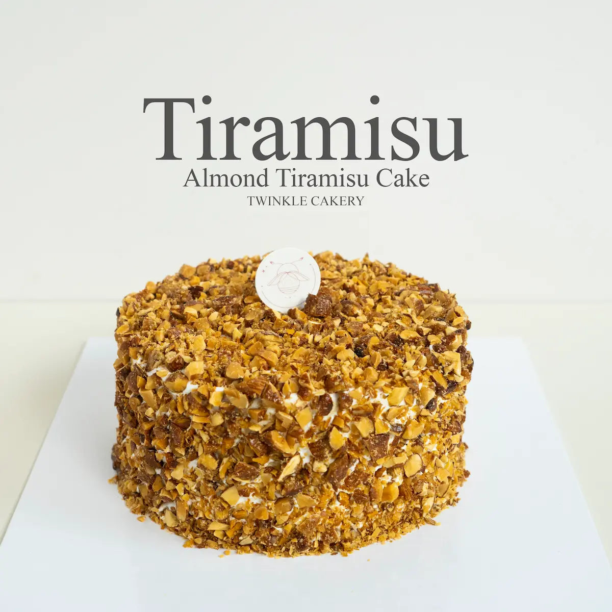 Alcohol free almond tiramisu birthday cake topped with toasted almonds and premium cream cheese frosting by Twinkle Cakery KL.
