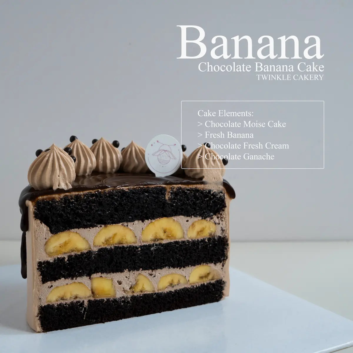 Cross section slice showing fresh bananas and light chocolate fresh cream between moist chocolate cake layers.