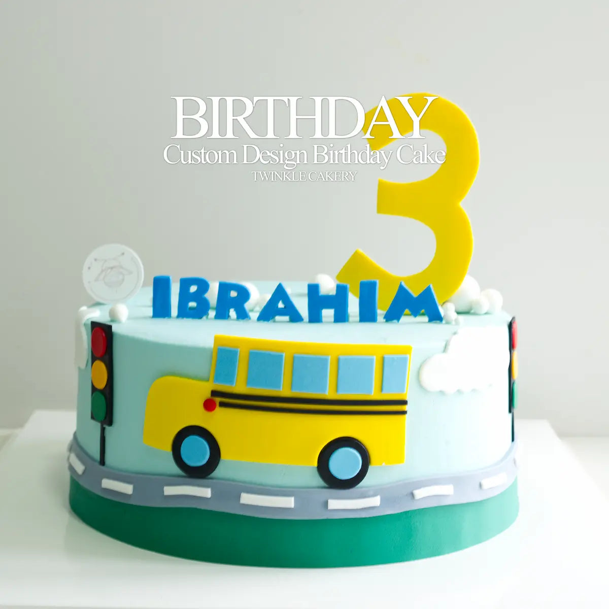 Yellow Bus birthday cake with fondant bus, traffic lights, road, and personalised name & number '3' on top. Delivery across Kuala Lumpur and Selangor.